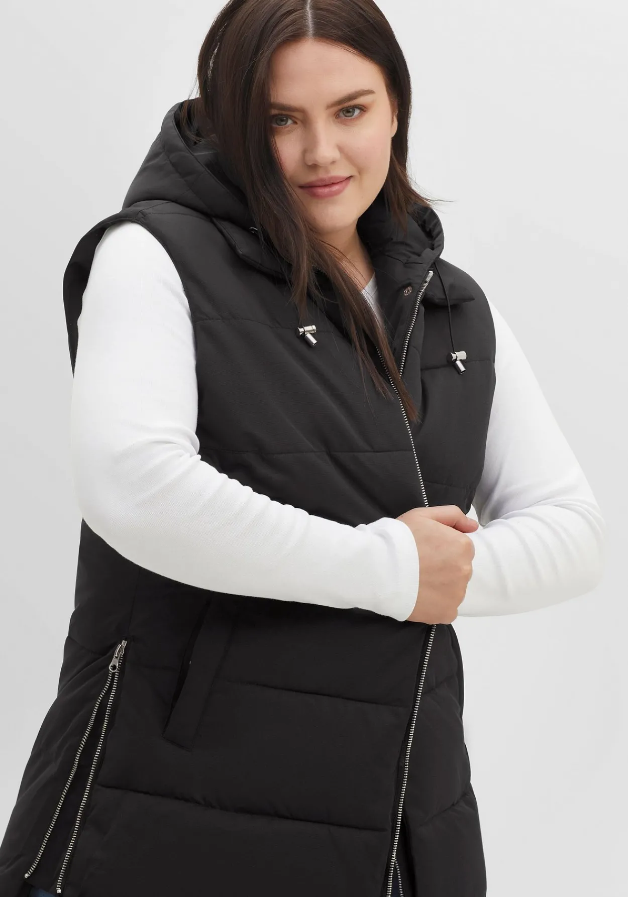 Lange Steppweste im Lagenlook, mit Kapuze<sheego Hot